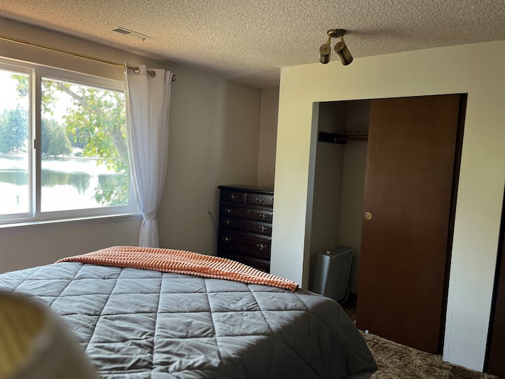 ตู้เสื้อผ้าสองชั้น แสดงให้เห็นเพียงชั้นเดียว อีกชั้นอยู่ทางขวา ตู้เสื้อผ้าเสริมในมุมข้างหน้าต่าง วิวทะเลสาบสวยงามจากหน้าต่างห้องนอน