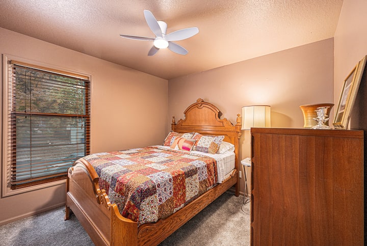 A cozy bedroom with a beautifully crafted wooden bed and soft, warm lighting, creating a comfortable and inviting space to unwind.