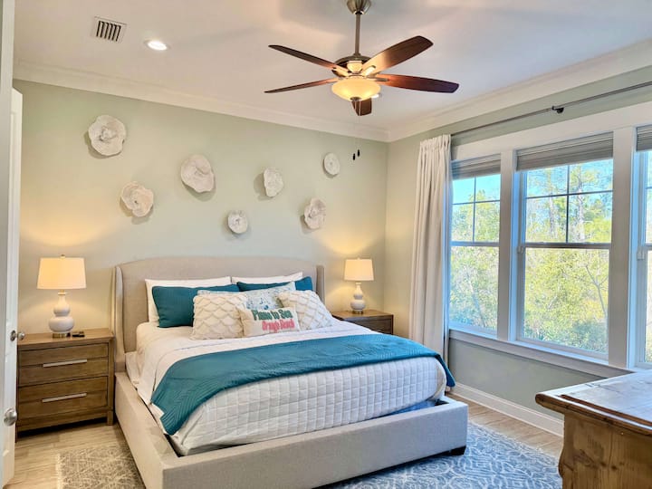 Cozy coastal bedroom with teal accents and natural light