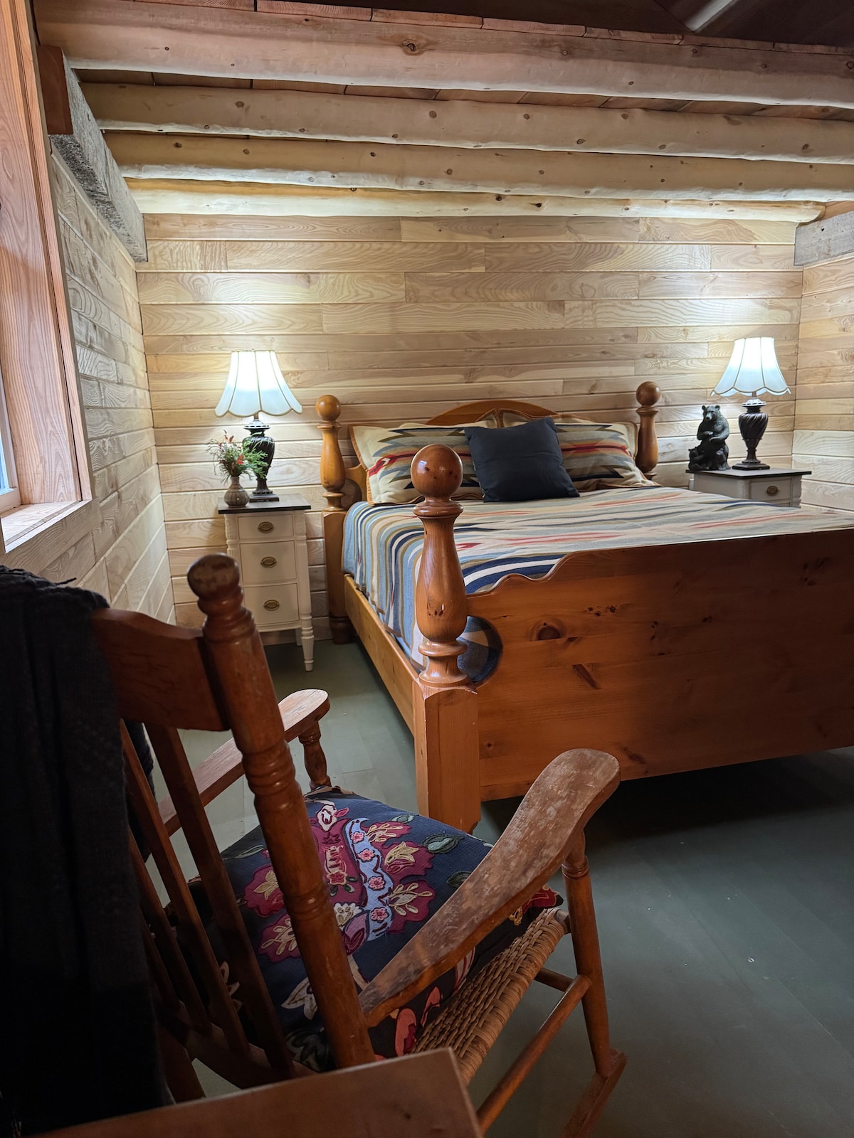 Queen bedroom with cozy bedding and peaceful forest views for a restful night’s sleepNewly updated and positioned for peaceful sleep with forest views across the private cabin property.