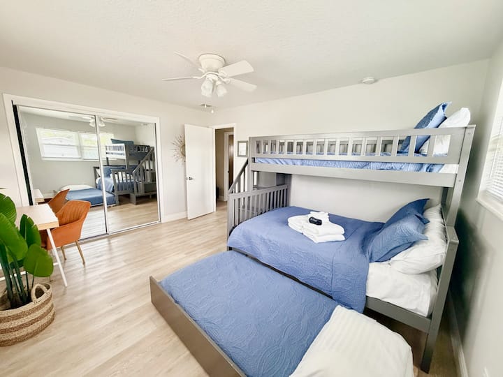 Bunk bed with top twin bed, middle full bed and twin trundle bed. Remote work desk and Smart TV.