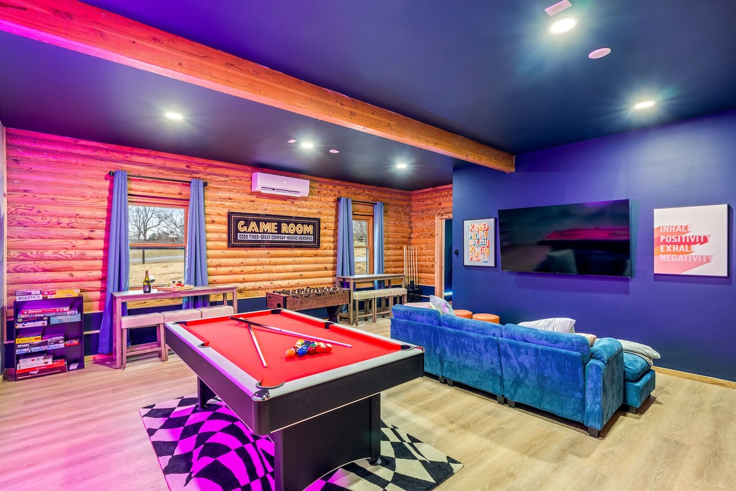 The game room with a pool table, comfy lounge seating, and a TV — for matches or a movie night.
