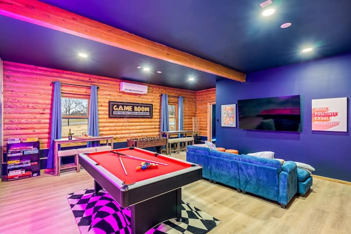 The game room with a pool table, comfy lounge seating, and a TV — for matches or a movie night.