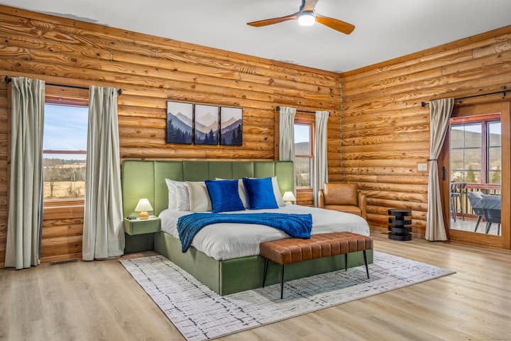 The king primary suite with a bedside coffee bar and a mountain-view window