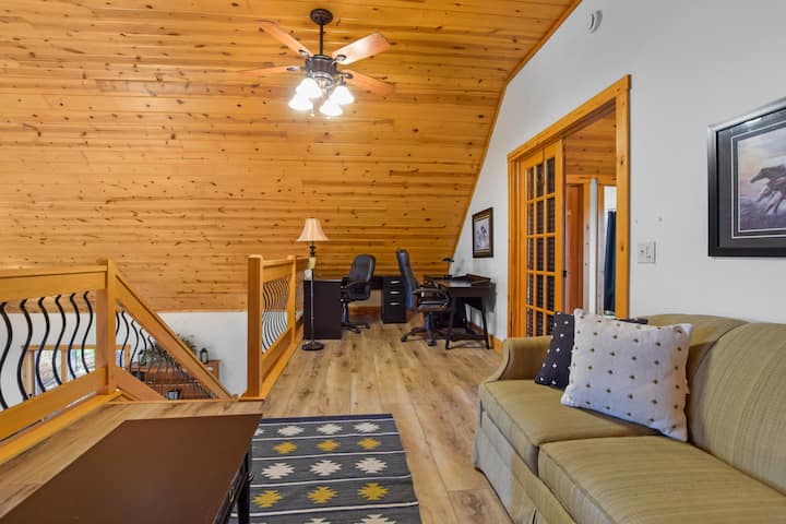 The loft area includes a comfortable pullout couch, perfect for kids or extra guests. (Note: open to the main living area.) A dedicated work space is also located nearby.