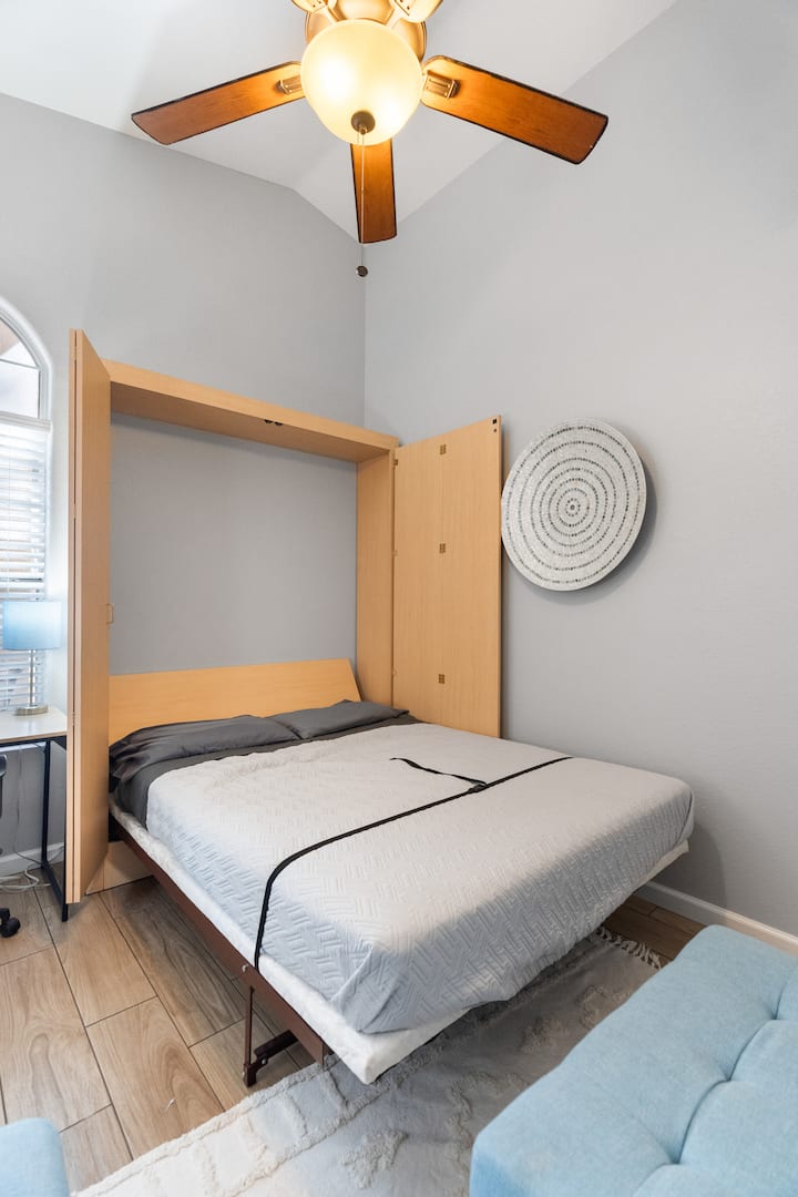 This multi-purpose room allows for a dedicated workspace, a quiet, get-away comfy couch & a queen murphy bed!  This room also has a ceiling fan, portable fan & luggage rack for your convenience.