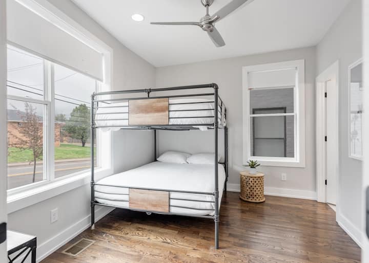 Modern bunk room with full-over-full beds, large windows, and bright, airy design—perfect for kids, friends, or extra guests in a fun, comfortable space.