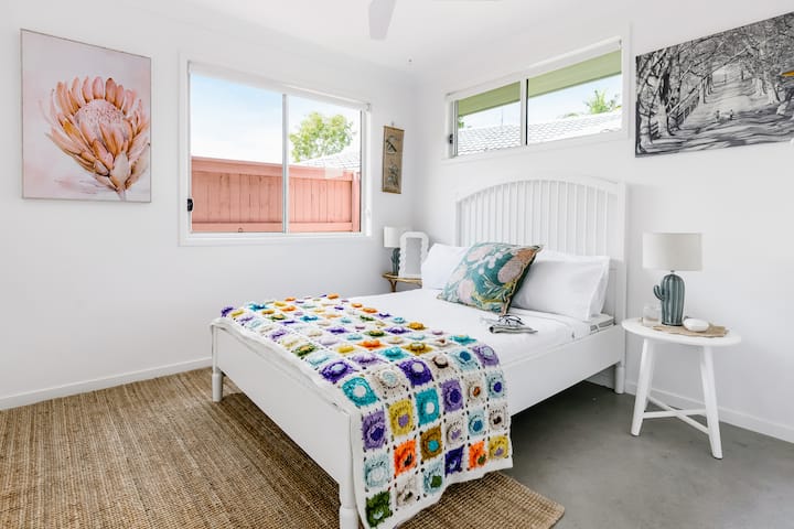 Double bed room filled with natural light, wardrobe, ceiling fan, mirror, and safe.
