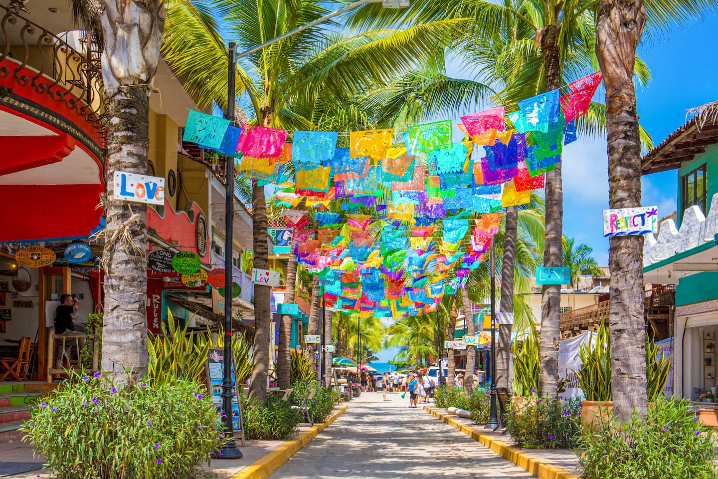Sayulita's main street, tacos and murals and papel picado overhead.