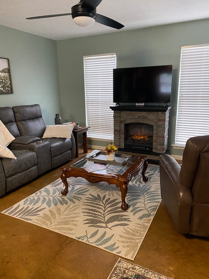 تحتوي غرفة المعيشة على مدفأة جديدة 