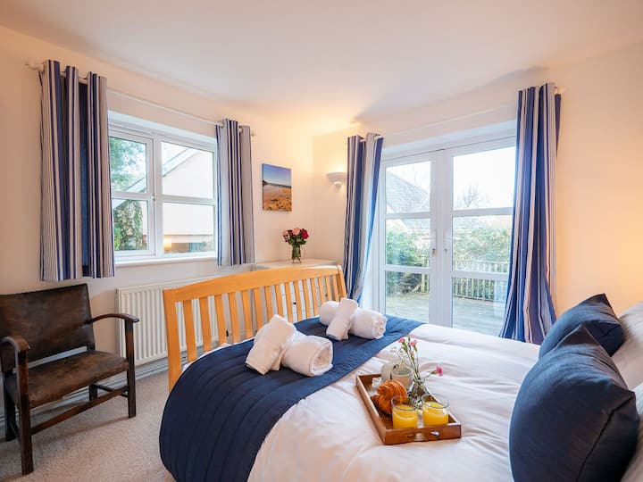 Bedroom with doors leading to the terrace and garden