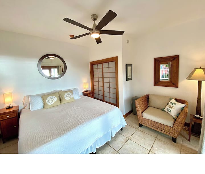 Lower level bedroom with King bed configuration and quaint seating area
