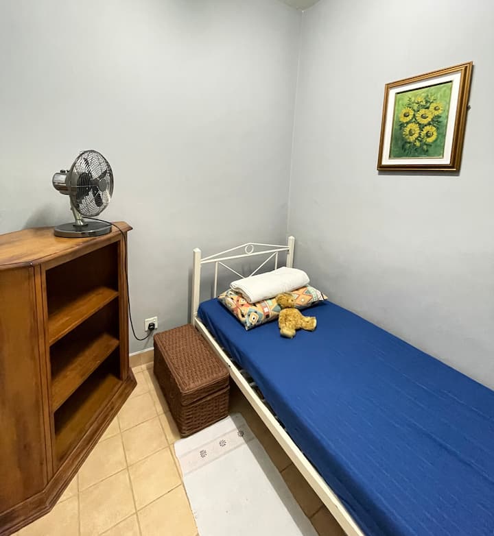 Single bed. Table fan. 