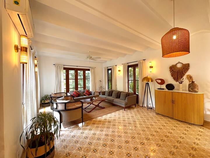 Soft neutral tones, elegant décor accents, and indoor plants add a calming, homely touch, while the open layout ensures plenty of space for everyone to gather comfortably.