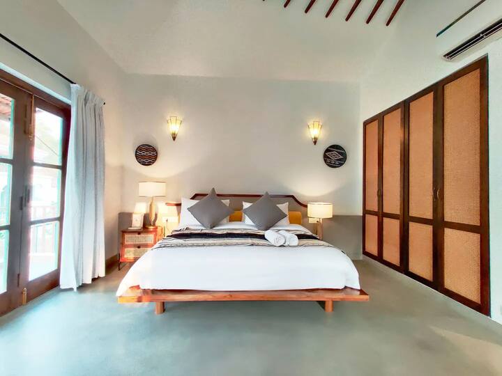 Designed for comfort and privacy, this luxurious bedroom features premium bedding, a seating area, a