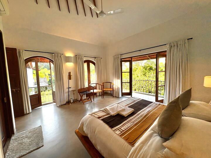 A bright and spacious luxury bedroom offering a comfiest bed with premium linens, ample wardrobe spa