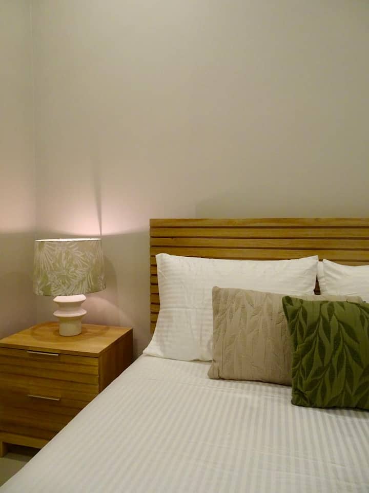 Queen bedroom designed for restful nights after exploring Nosara.