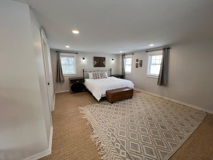 King bed in loft with blackout and light filtering curtains and 65" smart tv with disney+/hulu bundle