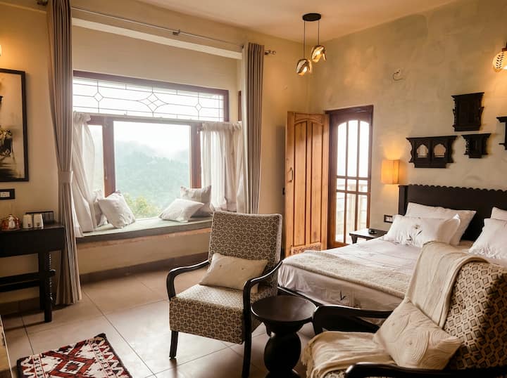 Space to breathe. This suite features a dedicated workspace, a heritage king bed, and a window lounge. Whether you're working remotely or journaling, the silence of the Bird Sanctuary inspires focus.