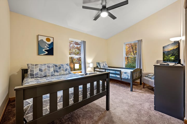 Spacious room with a full and twin sized bed.