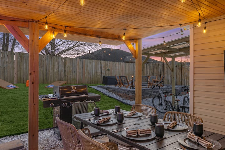 Al fresco dining under string lights with grill and patio seating