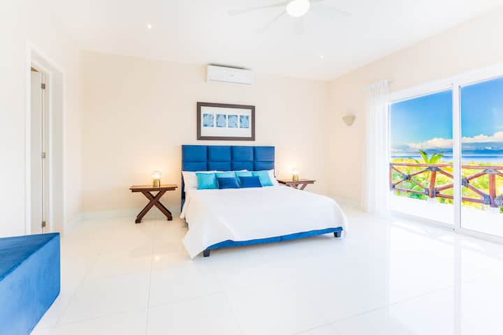King bedroom with soft island tones.