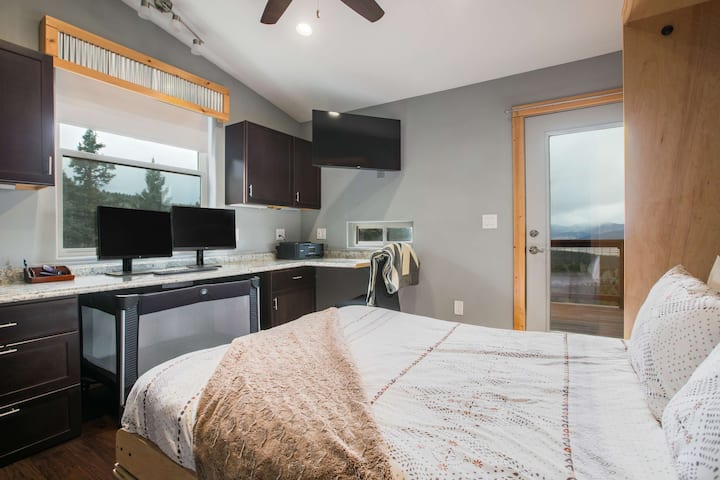 Murphy bed open. Door to upper deck. Office desk with dual monitors and incredible view. TV. Fan. 