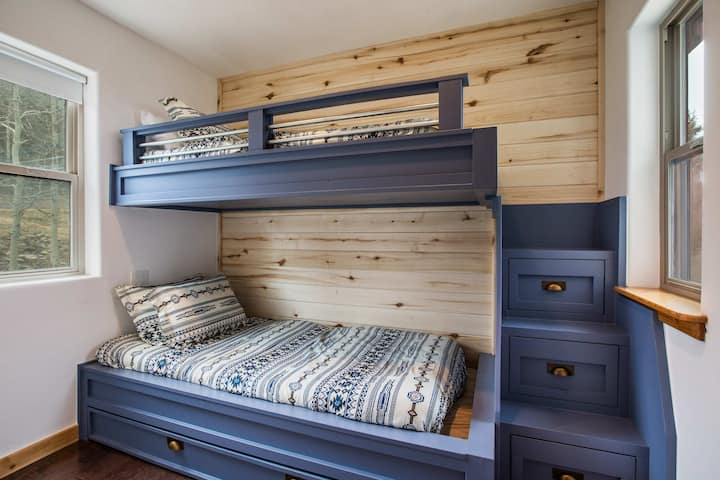 Three twin beds. Bunk beds with trundle in the cozy space. Dual aspect windows with views either side of the home.