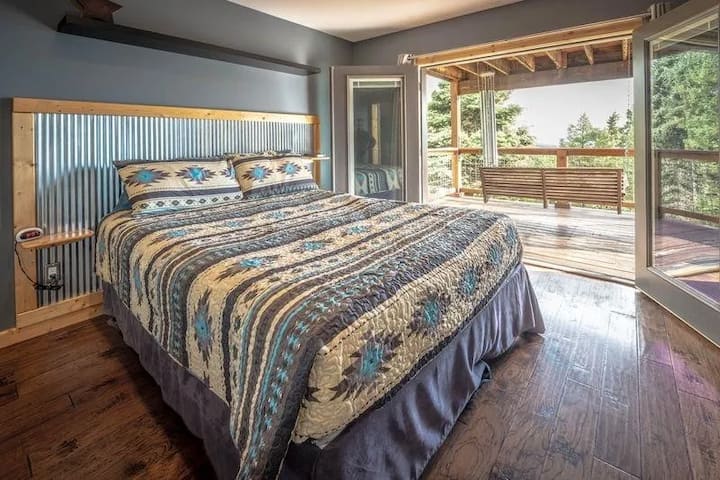 Primary bedroom opens to a private deck with forest views and a porch swing. Wake to sunrise over the Moreno Valley, sip coffee with birdsong, and watch deer wander our 6-acre ridge. Queen bed, fresh mountain air, and starry nights.