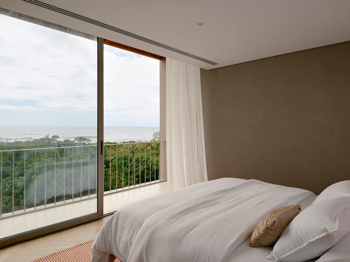Two master bedrooms with sea view, balcony, air conditioning, mosquito net, king size bed and different pillow heights.
