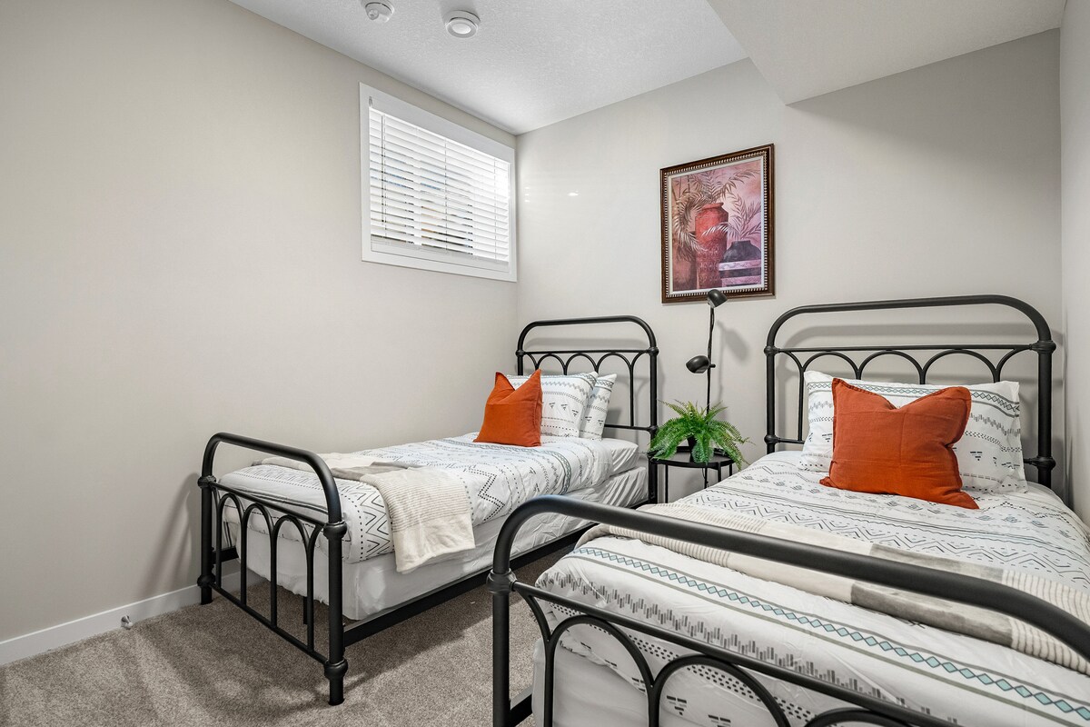 第二间卧室配有两张单人床、一个衣柜和遮光窗帘。