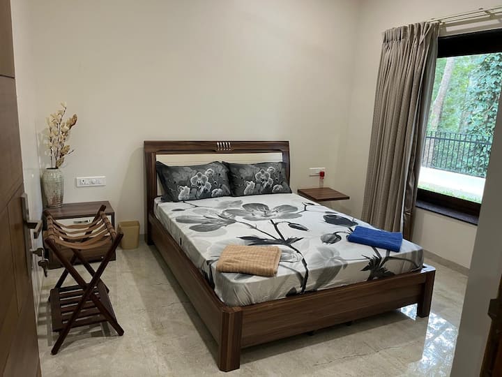 El dormitorio está equipado con cama doble con 2 almohadas, mesa auxiliar, unidad de almacenamiento y ventilador de techo.