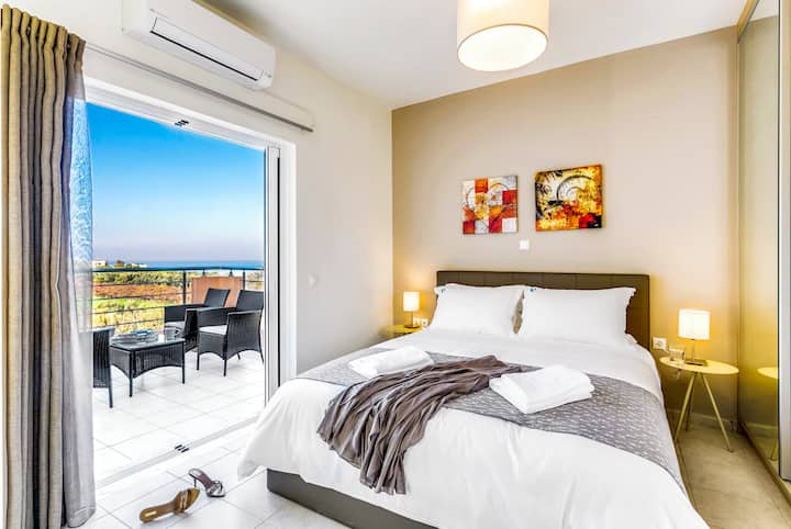 Second Floor: Master bedroom 1 with queen bed, ensuite bathroom with bathtub and private balcony