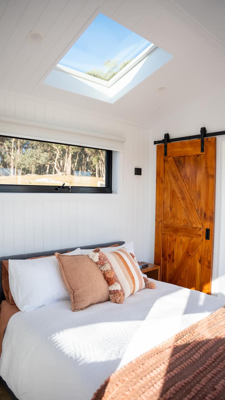 Luxury linen and ultra-comfy bed & pillows. Cupboard storage behind bathroom barn door