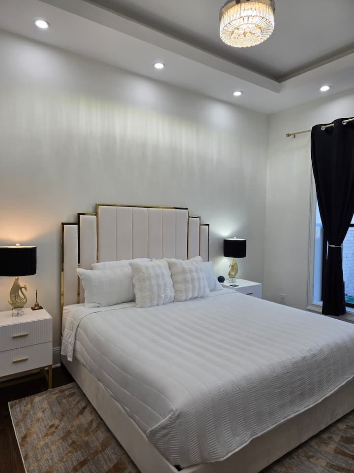 King bed with full ensuite bathroom and flatscreen TV. The ceiling light has a fan that is activated by a remote.
