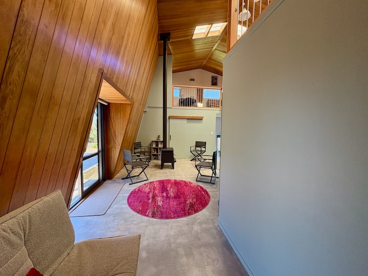 The downstairs space, seen from the hallway, is a cool place to sit on hot afternoons or the directors' chairs can be taken outside as you like.