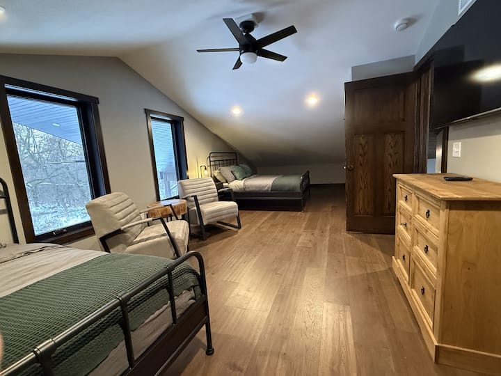 Lofted bedroom space showing sitting area and queen bed