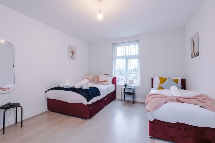 Comfortable bedroom with twin beds and bright, airy atmosphere"