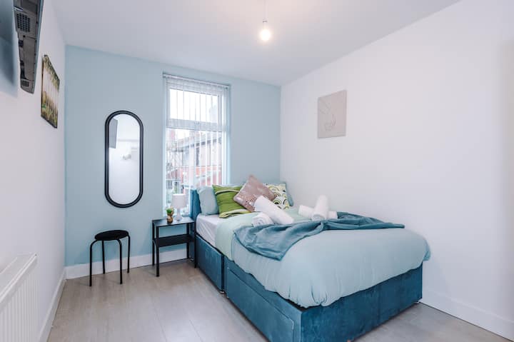 Cosy bedroom with soft blue tones and comfortable bedding