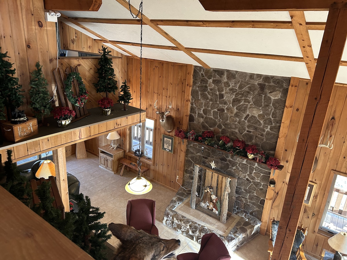 Vaulted Great Room with Decorative Stone Feature & Timber Loft