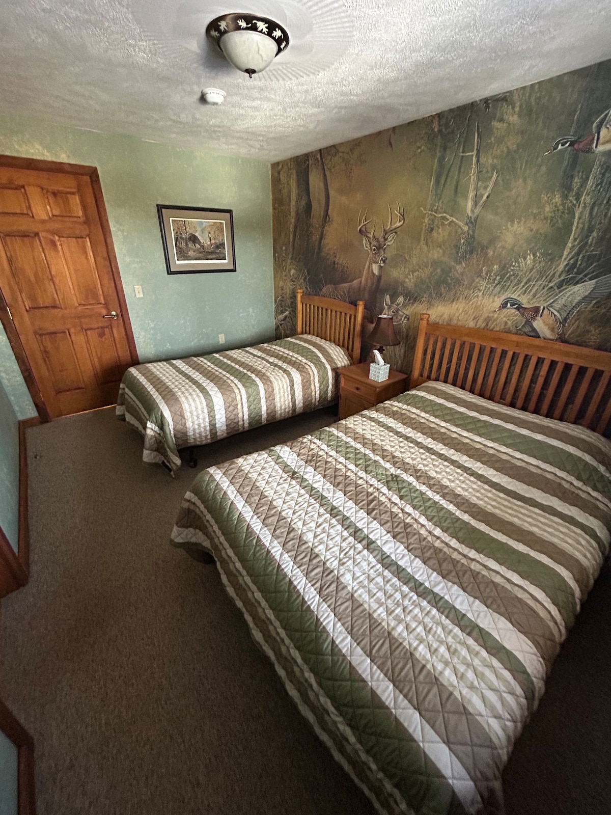 Bedroom 1 — Twin Bed & Double Bed with Woodland Wallpaper