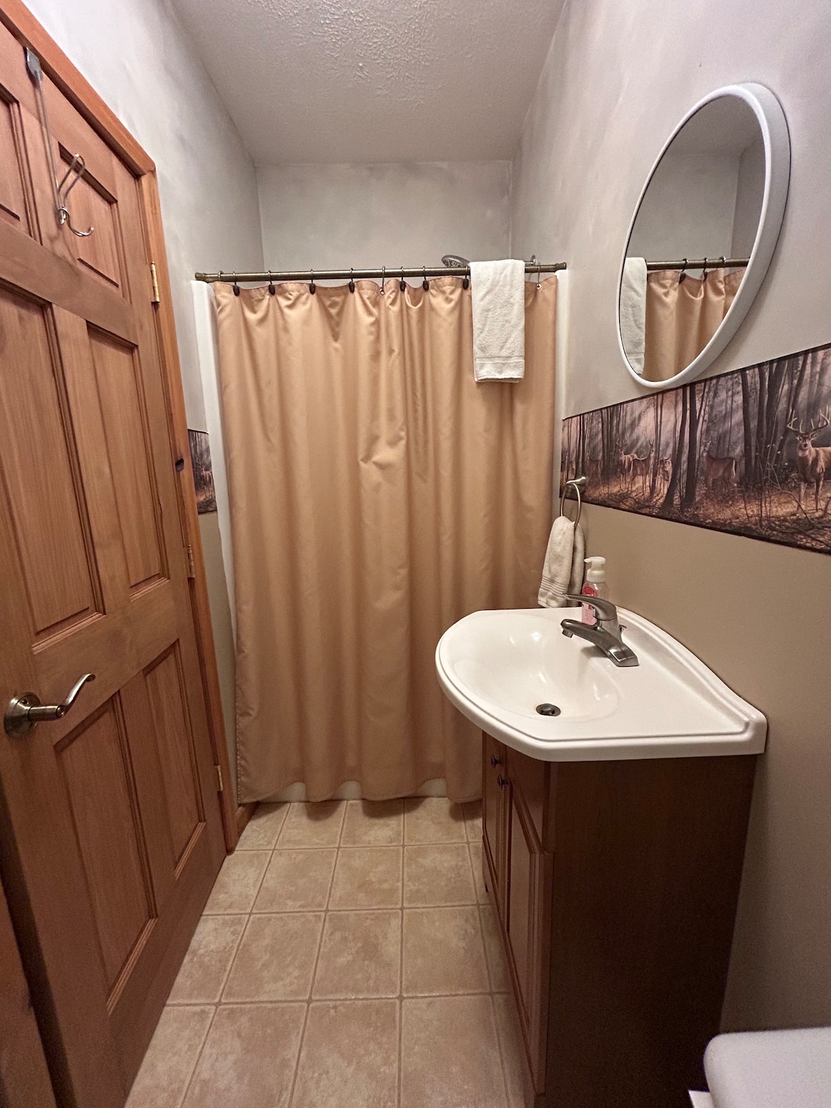 Full Bathroom 3 — Wooden Trim, Oval Mirror & Vanity