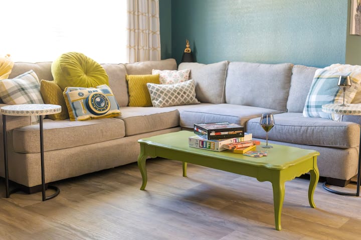 Spacious, pet-friendly living room with 65-inch Smart TV and cozy seating for the whole family.