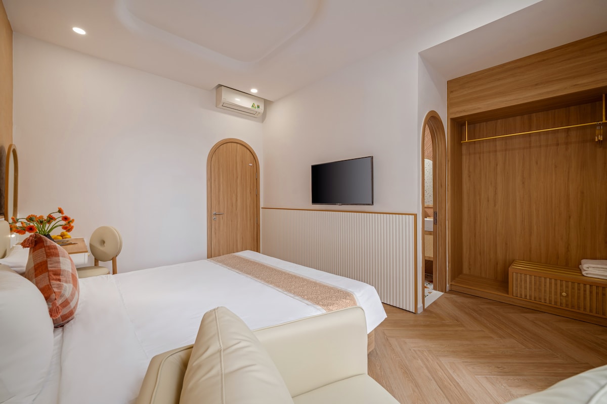 Habitación Deluxe en la parte trasera del 2do piso con cama king de 1,8m, baño en suite, grandes ventanales con vista a la piscina, escritorio, sofá, Smart TV, aire acondicionado, armario, iluminación cálida, lámparas de lectura y ropa de cama de alta calidad para una estancia relajante.