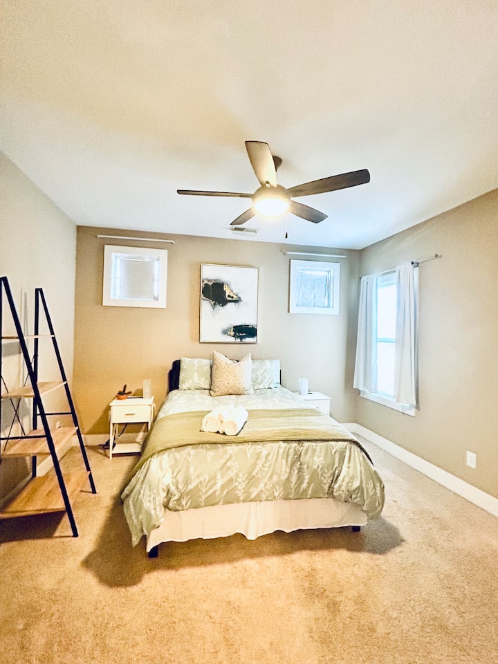 Second bedroom features a dreamy queen-size bed, private sink area, and shared “Jack-and-Jill” bathroom.