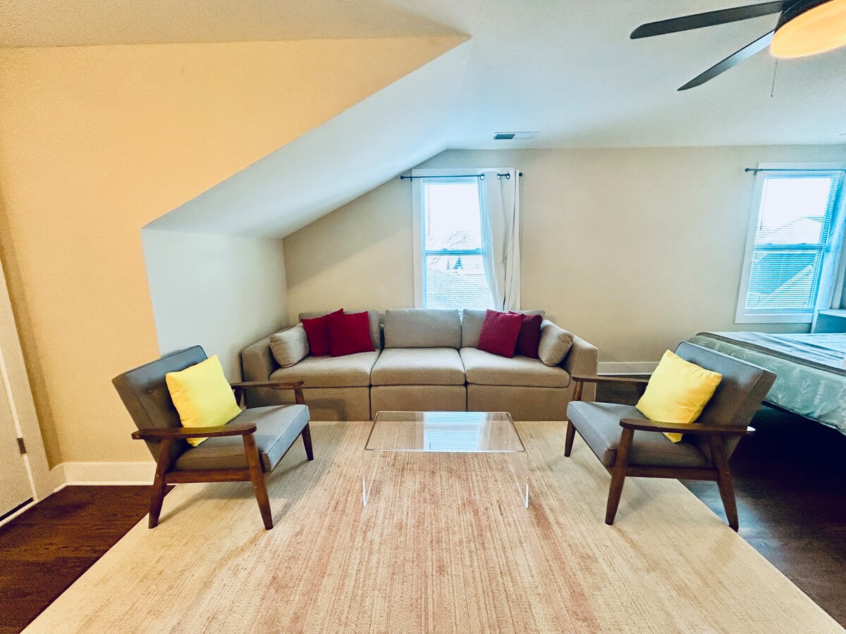 Comfortable sitting area with sofa and chairs in this private “loft” style third-floor bedroom.