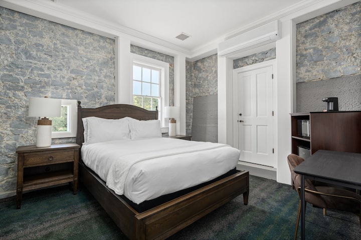 This is the private room you will be renting featuring a cozy queen size bed and historic stone-accented walls.