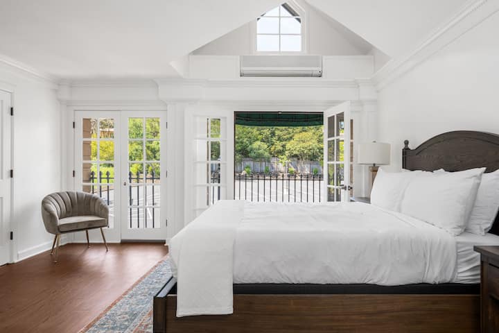 This is the private room you will be renting featuring vaulted ceilings, abundant sunlight, and balcony-style doors that open to peaceful views.