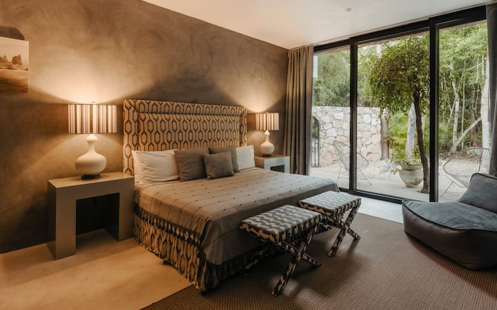 A refined king bed, plush seating and a peaceful patio define the third bedroom, creating a serene space with its own quiet story.
