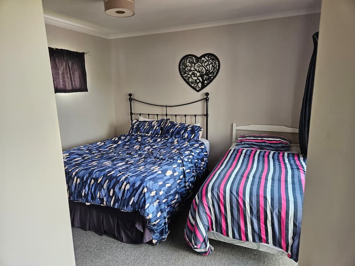 this bedroom faces the deck and has one QueenBed and one Single Bed